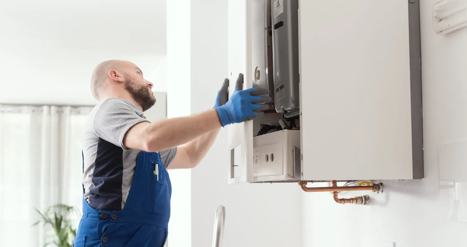 A professional technician doing a boiler inspection in a house.